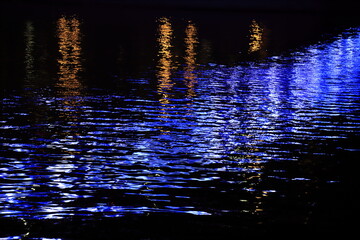 Night city lights reflected in the water