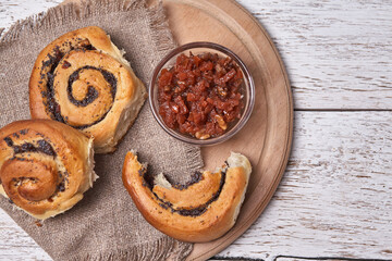 Tasty buns with raisins on a white rustic wooden table. fresh bakery. breakfast. bread. top view