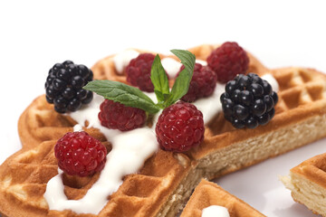 Belgium waffles with fresh berries isolated on white background