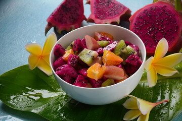 Dragon fruit (Pitaya, Pitahaya).Sliced pieces pitahaya fruit and fruit salad,and frangipani flowers.