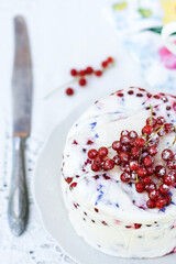 Homemade dessert of yogurt , berries and gelatin, decorated with raw red currants and knife nearby in white background, fresh, healthy food  concept