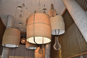 electric lamps with fabric lampshade under the ceiling of the building