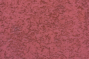 structure of textured plaster on red wall