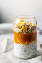 GRANOLA WITH YOGHURT AND CHIA SEEDS IN A GLASS CLEAR GLASS