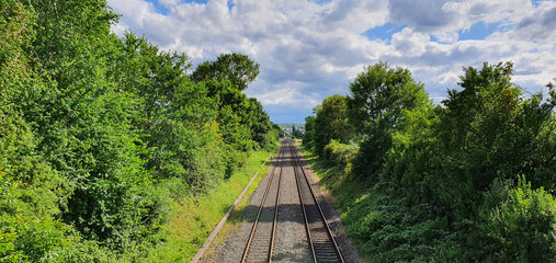 Bonn Germany June 2020 railway line surrounded by trees against blue sky