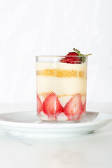 jar of strawberry pudding magnolia desert over white backdrop
