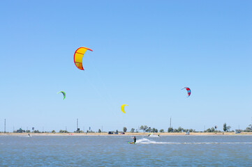 people on the lake are kitesurfing