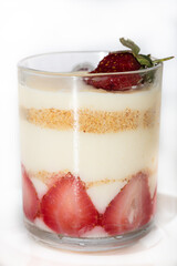 jar of strawberry pudding magnolia desert over white backdrop