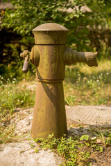 Fototapeta premium old rusty water column in the village