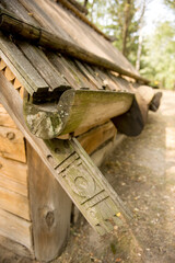Part of a historic dwelling, carved underlayment, roof and under-roof gutter in a 17th century wooden hut