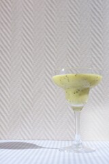 green kiwi and banana cocktail in a glass