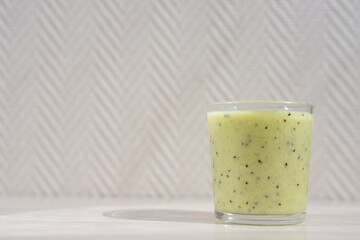 green kiwi and banana cocktail in a glass