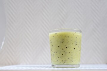 green kiwi and banana cocktail in a glass