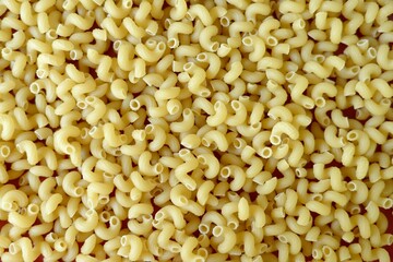pasta (noodles) sprinkled on a wooden background
