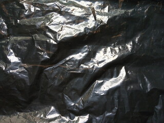 black wrinkled polythene textured background