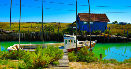 multicolored oyster shed and boat at Oleron Island