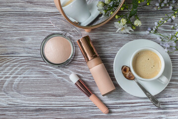 Decorative cosmetic make up tools and coffee cup. Breakfast and make up set. Concept of female mockup.