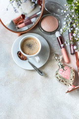 Decorative cosmetic make up tools and coffee cup. Breakfast and make up set. Concept of female mockup.
