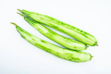 Fresh peeled loofah on white background