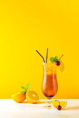 Glass with water drops of the Sex on the beach cocktail on yellow background. Close up, shallow depth of the field, copy space for you text.