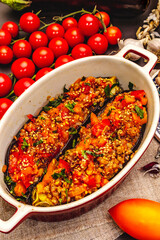 Karniyarik traditional Turkish food from stuffed eggplants with minced meat, tomato, greens and sesame seeds