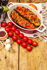 Karniyarik traditional Turkish food from stuffed eggplants with minced meat, tomato, greens and sesame seeds