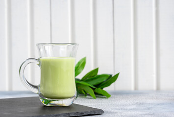 Matcha cappuccino with almond milk cup close-up