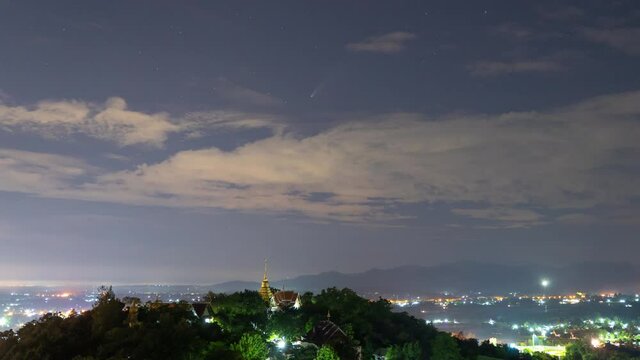 4K Time lapse of  C/2020 F3 (NEOWISE) comet at night among the stars above Doi Saket Temple in Chiang Mai Thailand on July 22, 2020.