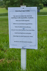 A sign outlining rules on a safe return to sport with coronavirus at an outdoor event in England