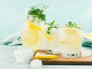Fresh lemon lemonade in jug and glasses