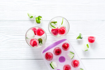 Raspberry and lime in ice cubes top view flat lay