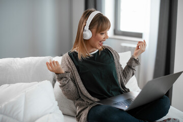 Young woman having video call. Beautiful woman enjoying at home..