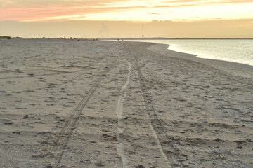 Fototapeta premium Sea coast during a colorful sunset on a slightly cloudy day.