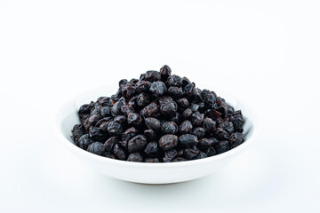 A saucer of black tempeh on white background