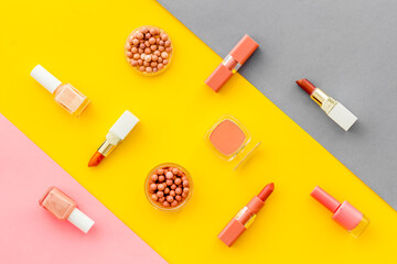 Lauout of multicolor cosmetics - powder concealer eye shadow lipstic. Top view