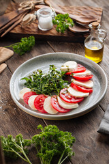 Classic italian caprese salad on the wooden table