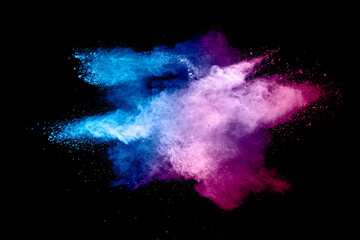 Abstract blue pink powder explosion on white background. Closeup of blue pink dust particles splash...