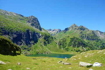 Fototapeta na wymiar Mountain lake called d'Espingo in Pyrenees mountains on a hiking trail GR10