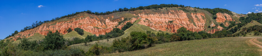 Panorama of Rapa Rosie - Red Ravine in summer under clear blues sky, Alba county, Romania