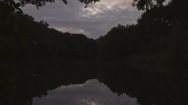 Time Lapse Sun set reflection on a lake surface with fade to black.
