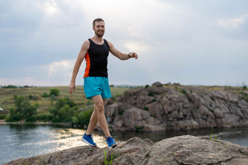 Male runner running over stones, copy of free space.