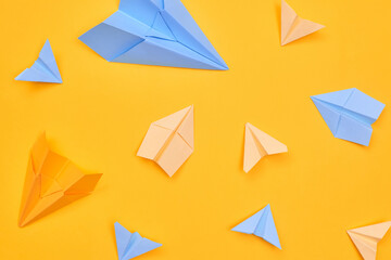 paper planes on a yellow background. travel flat layer