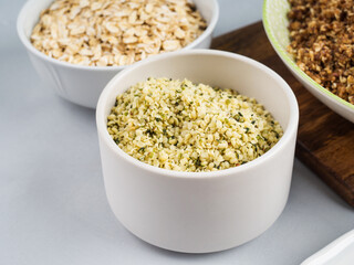 Shelled hemp seeds superfood in white bowl