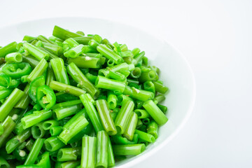 Stir-fried convolvulus with green pepper on a dish of home cooking on white background