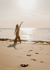 Women's footprints in the sand during sunset. Vertical background