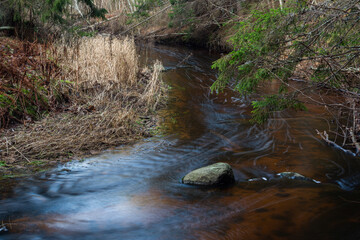A small rocky river in spring taken in Latvia with long exposure