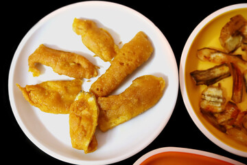 South Indian Potato Snack, Vazhakkai Bajji served on black background