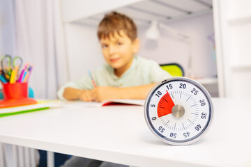 Timer and little boy during development therapy lesson on background