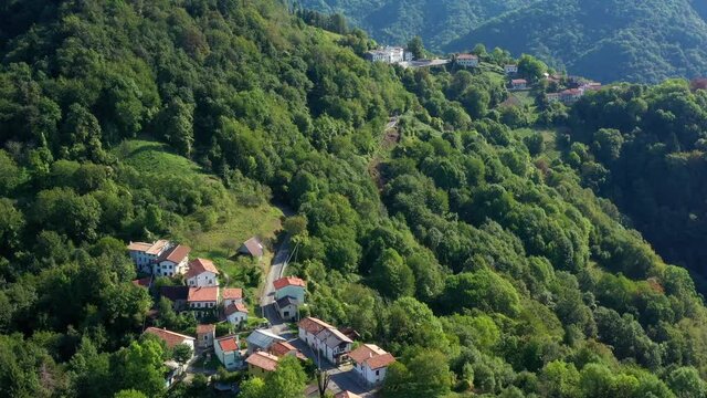 Beautiful small Italian village in mountains. aerial drone video footage of Topolo municipality of Grimacco, in the province of Udine, region Friuli-Venezia Giulia north-eastern Italy. Small town 