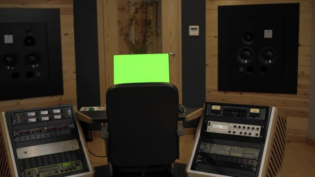 empty sound design mastering studio with monitor with chromakey on camera dolly pan movement